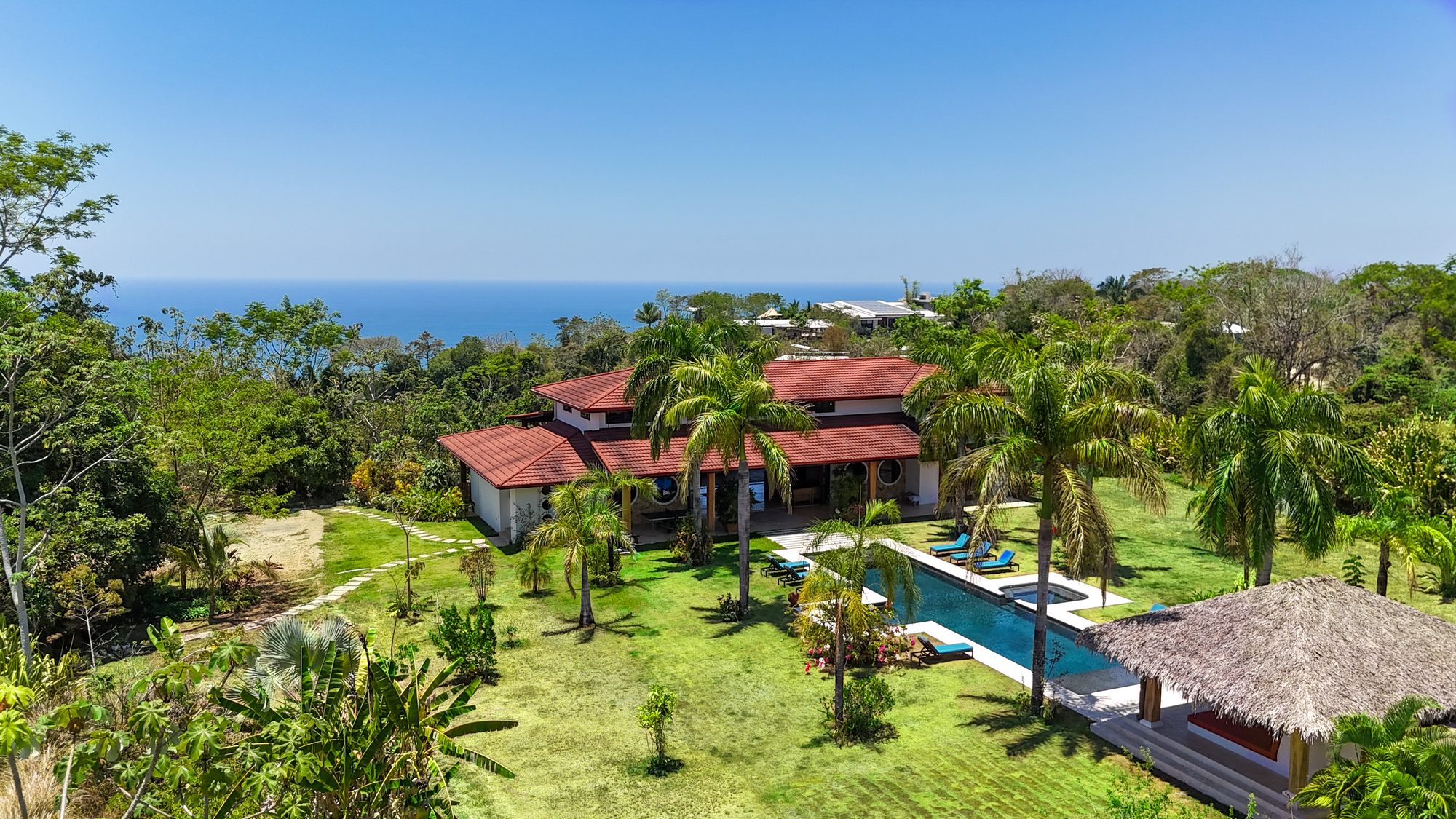Aerial view of Tanit Villa, its pool and gardens above the Pacific